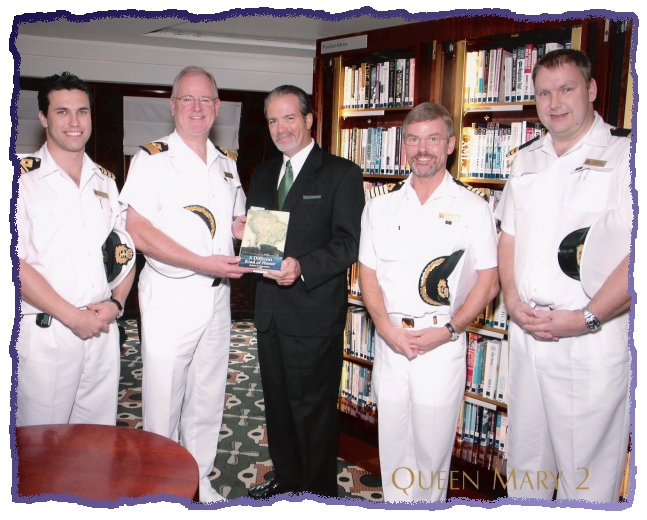 Robert N. Macomber aboard Queen Mary 2 with Commodore Warner and senior officers